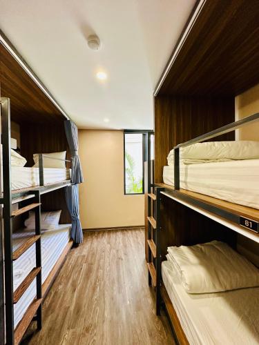 a room with three bunk beds in a dorm at NinhBinh Buffalo Hostel in Vũ Lâm