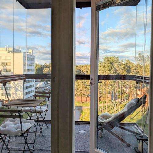a balcony with a view of a table and chairs at Henniina V Kotoisa - Free parking & Easy Check-in in Oulu