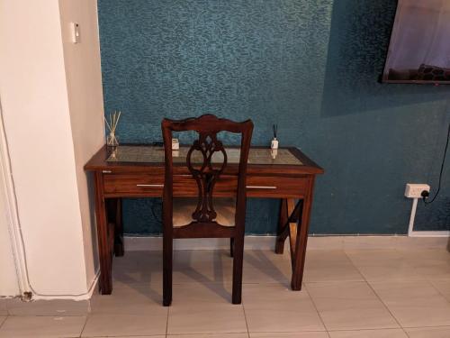 a wooden desk with a chair in a room at The Zola lantana Westlands in Nairobi
