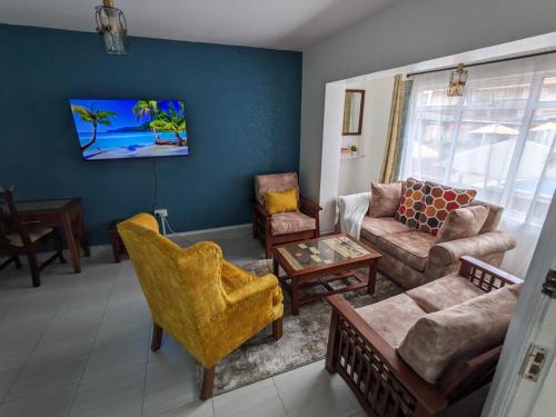 a living room with a couch and chairs at The Zola lantana Westlands in Nairobi