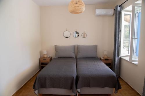 a bedroom with a bed in a room with a window at Villa Marina in Posidhonía