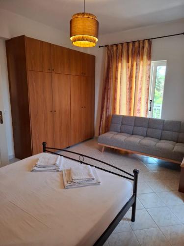 a living room with a bed and a couch at Rousela apartment in Vasilikos