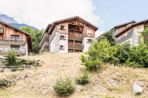 a building on the side of a hill at Appartement spa fleures d'Orelle in Orelle