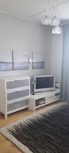 a living room with a flat screen tv on a wall at Harju Rally with sauna in Jyväskylä