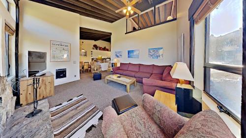 a living room with a couch and a table at Beautiful 4 Bed Condo with Top Of The Hill Views! in Mammoth Lakes