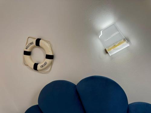 a close up of a blue couch and a fan at Lighthouse Apartaments Shengjin in Shëngjin