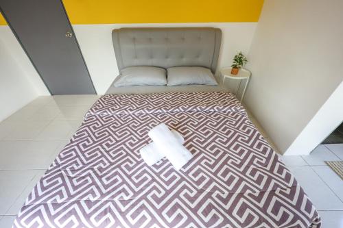 Ένα ή περισσότερα κρεβάτια σε δωμάτιο στο Family Adventure Homestay in Cameron Highlands Clover Home 6-30