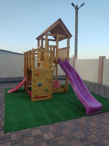 a playground with a slide and a play structure at Три Слона in Zatoka