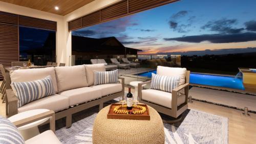 a living room with a couch and chairs and a pool at HOKU LANI HOUSE Heated Private Pool Spa Intro Pricing 25% off in Waimea