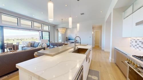 a kitchen and living room with a large window at HOKU LANI HOUSE Heated Private Pool Spa Intro Pricing 25% off in Waimea