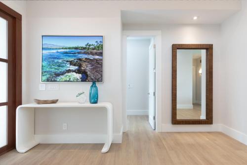 a living room with a white console table and a mirror at HOKU LANI HOUSE Heated Private Pool Spa Intro Pricing 25% off in Waimea
