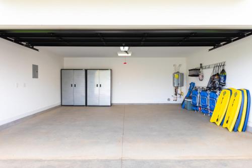 an empty garage with yellow equipment in it at HOKU LANI HOUSE Heated Private Pool Spa Intro Pricing 25% off in Waimea