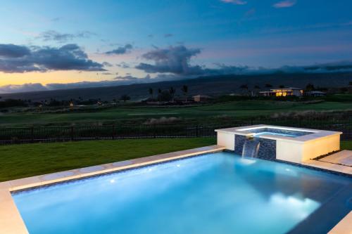 a swimming pool with a view of a golf course at HOKU LANI HOUSE Heated Private Pool Spa Intro Pricing 25% off in Waimea