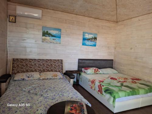 a bedroom with two beds and a table at Relax and chill Villa in Chornomorsk