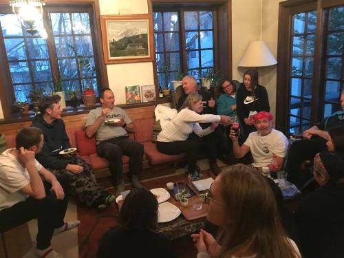 a group of people sitting in a living room at Pension Belnina in Hakuba