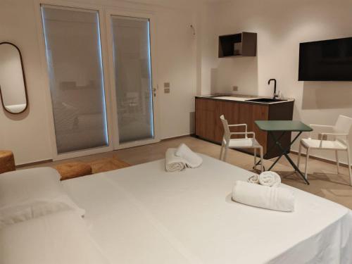 a room with a white bed with two towels on it at Dimora Cala Graziosa in Favignana