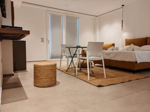 a bedroom with a bed and a table and a chair at Dimora Cala Graziosa in Favignana