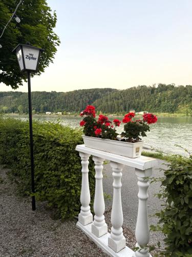 a white table with flowers on it next to a street light at La Veneziana Guesthouse in Aschach an der Donau