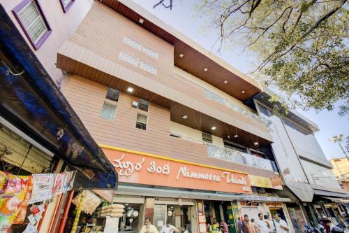 a building with people walking in front of it at Hotel O Abhimaani Inn in Bengaluru