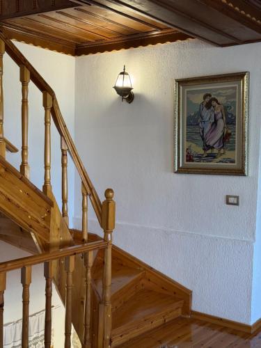 a stairway with a picture of a woman on the wall at Castle Hotel in Gjirokastër