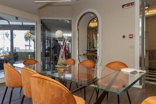 a glass table with orange chairs in a store at Splendide Riviera Boutique Art Hotel in Rapallo