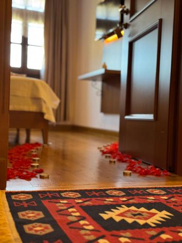 a room with a rug on the floor next to a door at Castle Hotel in Gjirokastër