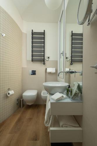 a white bathroom with a sink and a toilet at Splendide Riviera Boutique Art Hotel in Rapallo