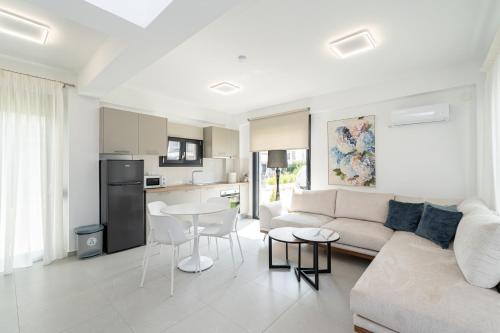 a living room with a couch and a table at Nefeli & Nefeli Luxury Residential Complexes in Ofrínion