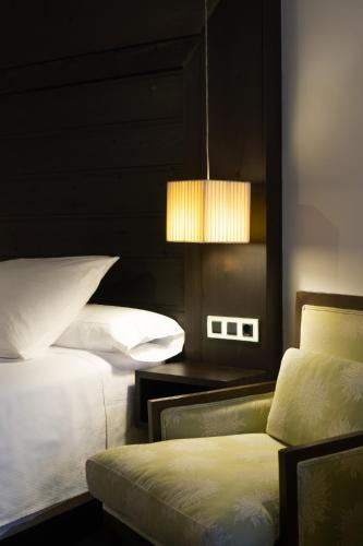 a bedroom with two beds and a light fixture at La Plaza in Hervás