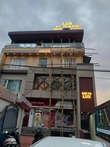 a building with a sign on the top of it at Hotel LUX by Heavenn in Dehradun