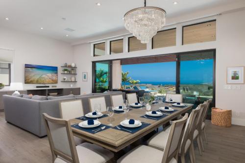 a dining room and living room with a long table and chairs at ❤PiH❤ BLUE TRANQUILITY Heated Private Pool Spa Detached Ohana Suite in Waimea