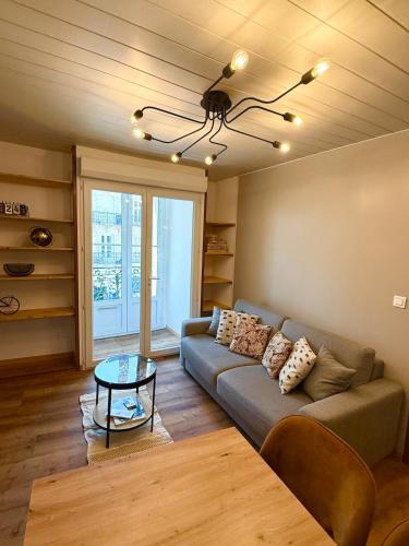 a living room with a couch and a table at Appartement La Pause Ponote, centre ville du Puy-en-velay in Le Puy en Velay