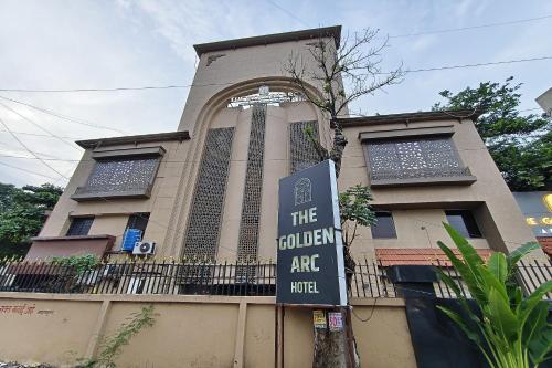 a building with a sign in front of it at The Golden Arc in Pune