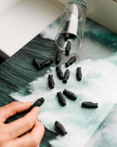 a person is sprinkling oreo cookies on a counter at Le Marin Hotel Rotterdam City - Handwritten Collection in Rotterdam