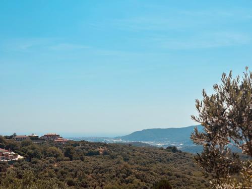 a view of a hill with trees and a city at Vitis Verde in Arnasco