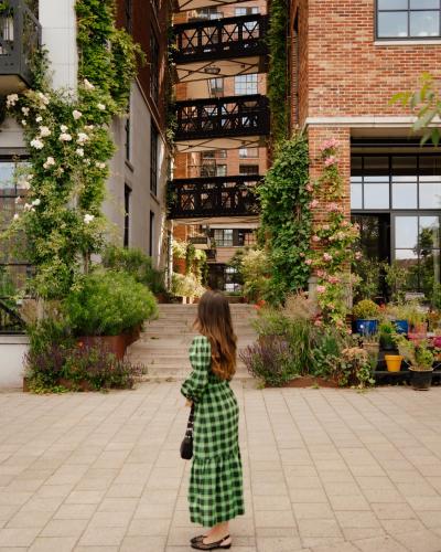 a little girl standing in front of a building at Le Marin Hotel Rotterdam City - Handwritten Collection in Rotterdam