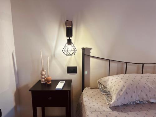 a bedroom with a bed and a nightstand with a lamp at Vitis Verde in Arnasco