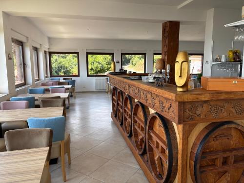a restaurant with a bar with tables and chairs at Domaine du Haut-Koenigsbourg in Orschwiller