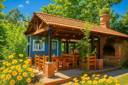 a small blue house with a table and a fireplace at Dream House in Batumi