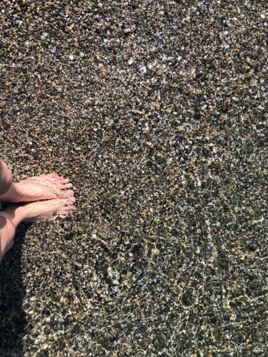 a person standing on the beach with their feet in the sand at PRECIOSO y EXCLUSIVO APARTAMENTO EN 1º LINEA DE PLAYA CON PARKING in Almuñécar