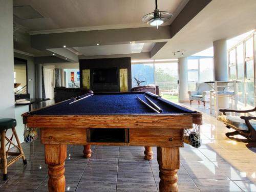 a pool table in the middle of a living room at LookOut Ramsgate in Ramsgate