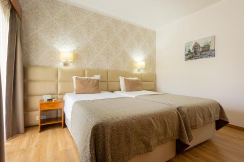 Ένα ή περισσότερα κρεβάτια σε δωμάτιο στο Hotel Sao Jorge Garden