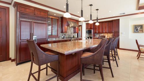 a kitchen with a large island with a marble counter top at ❤PiH❤ Ikena Nani Ocean Coastline Views Mauna Kea Resort in Waimea