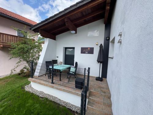 a patio with a table and chairs on a balcony at Apartments 30-11 in Ehrwald
