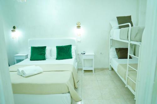 a room with two beds and a bunk bed at Bee Queen Hotel in Marina di Varcaturo