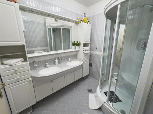 a bathroom with two sinks and a shower at Luxury Beachfront Apartments Matista in Trogir
