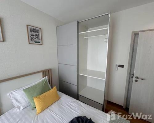 a bedroom with a bed and a glass closet at VE1 Halo 2-bedroom ВатСaп66935B2I976 in Nai Yang Beach