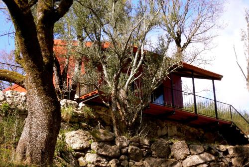a house on top of a stone wall with a tree at GoToGeres - Casa da Eira - Sobrenatura in Arcos de Valdevez