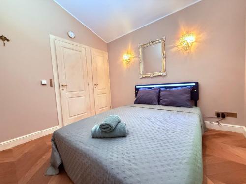 a bedroom with a bed with a blue towel on it at Pétrusse Élite Suites in Luxembourg