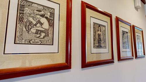 a group of framed pictures hanging on a wall at ❤PiH❤ OCEAN BREEZE Panoramic Ocean View Mauna Kea Resort Optional Privileges in Waimea